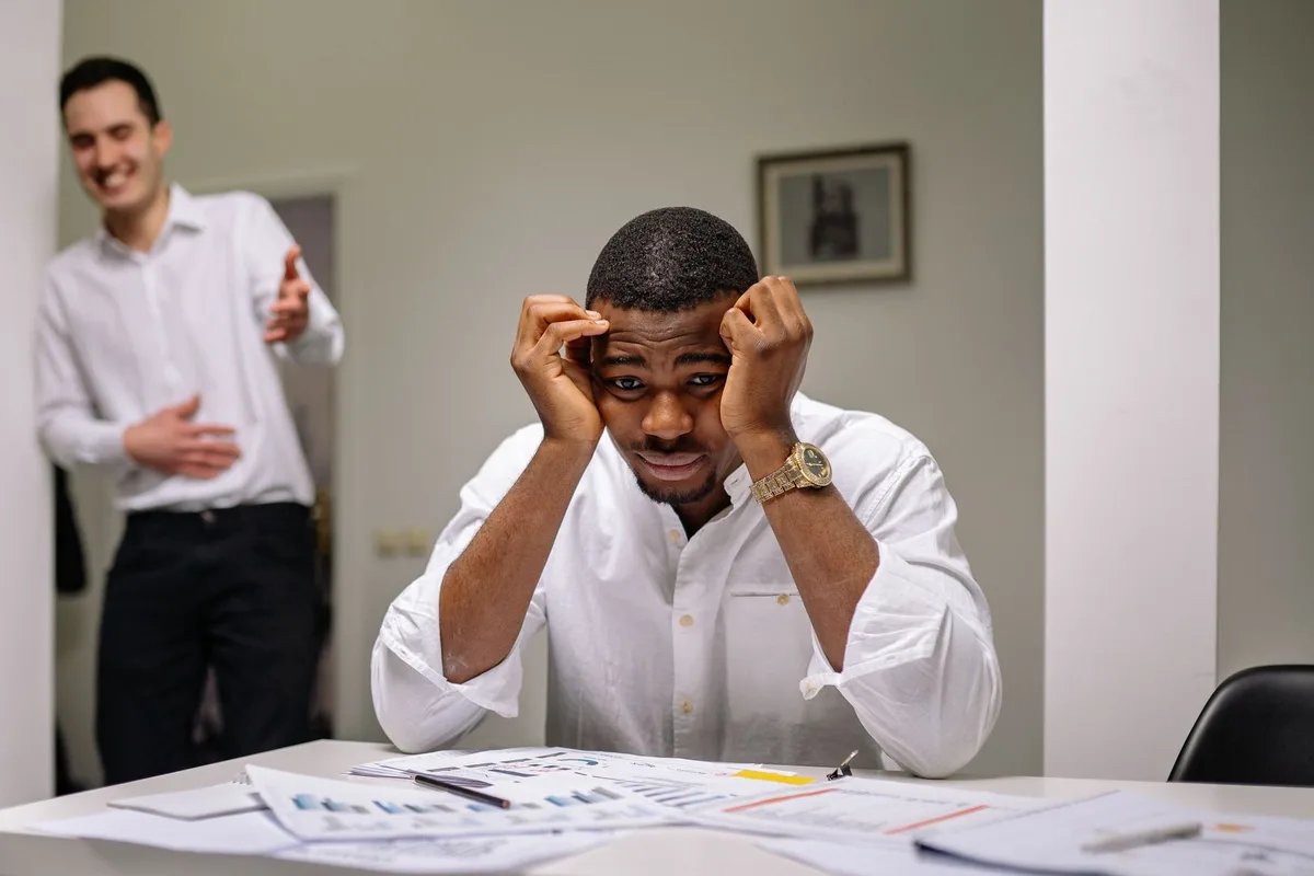 Personne fatiguée à son poste de travail, montrant des signes de stress et d'épuisement professionnel.