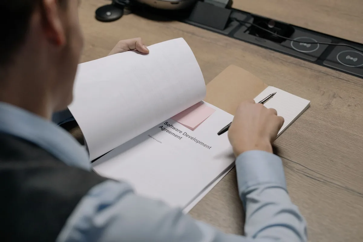 Documents de rupture conventionnelle et contrats étalés sur un bureau pour vérification.