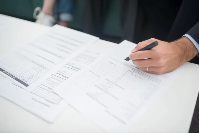 Contrats de travail et documents RH sur un bureau, symbolisant la conformité légale en droit du travail Contrats de travail et documents RH sur un bureau, symbolisant la conformité légale en droit du travail
