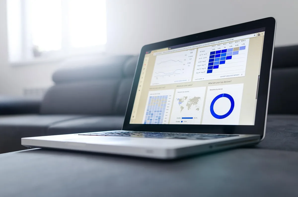 Équipe finance autour d'un ordinateur consultant un tableau de bord de dépenses